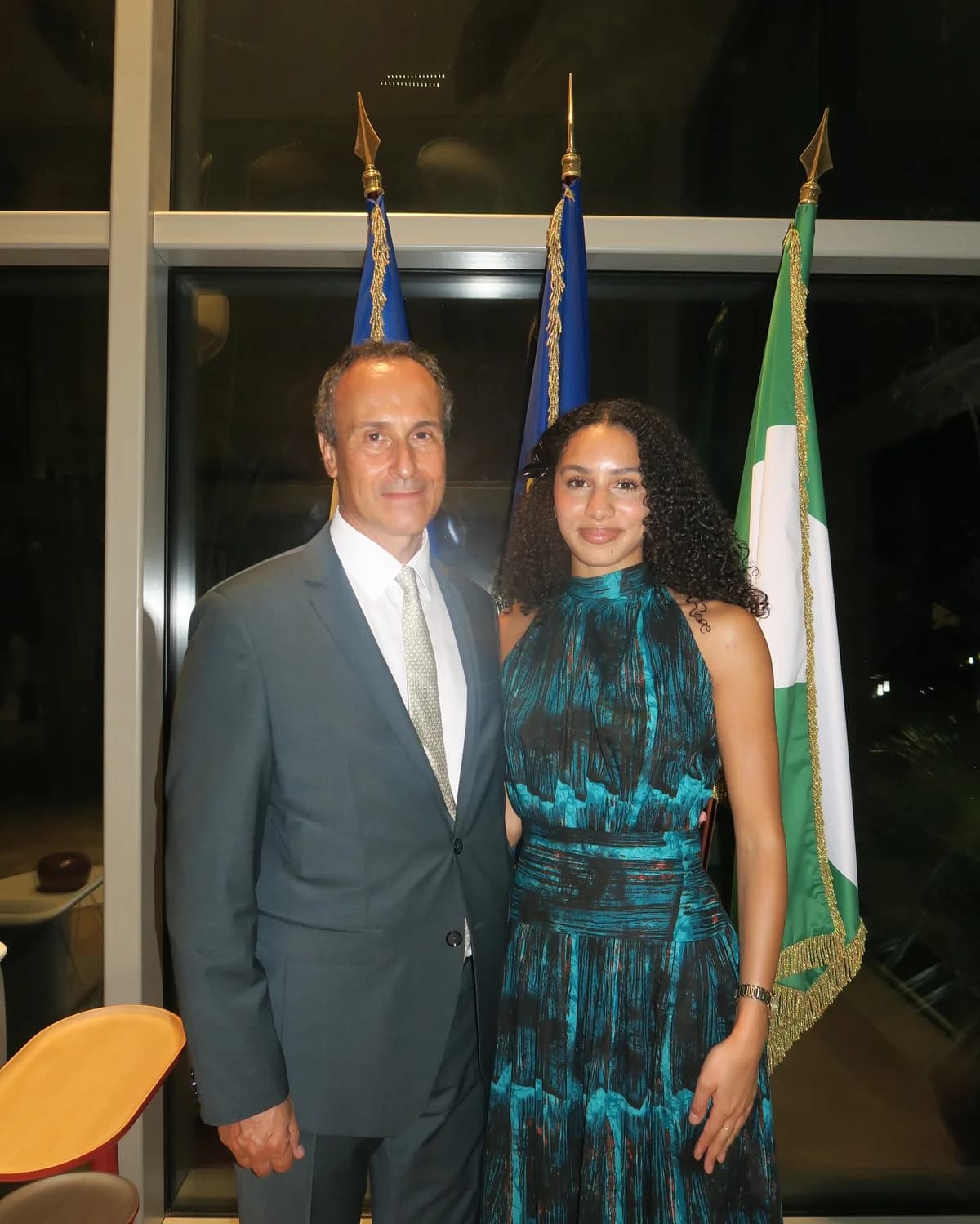 Rachel Ogechi Kanu with French Ambassador Marc Fonbaustier in front of the French, European Union and Nigerian flags